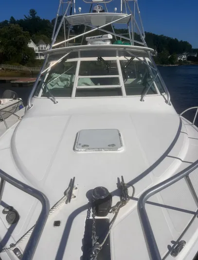 Miss Madison Yacht Photos Pics 2003 Cabo Express boat on water, featuring sleek design and spacious deck.