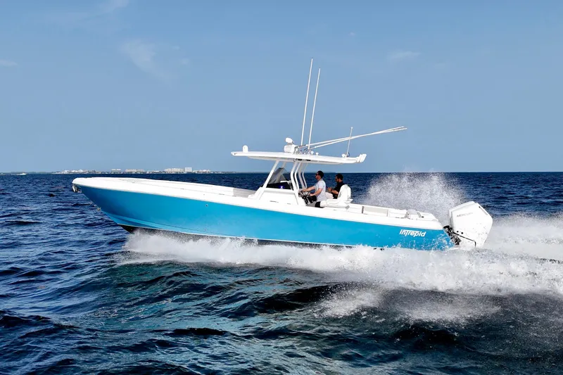 V10 400's Yacht Photos Pics 2015 Intrepid 375 Center Console boat cruising on open water, blue hull, clear sky.