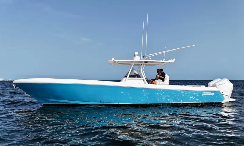 V10 400's Yacht Photos Pics 2015 Intrepid 375 Center Console boat on open water, featuring a sleek blue hull.