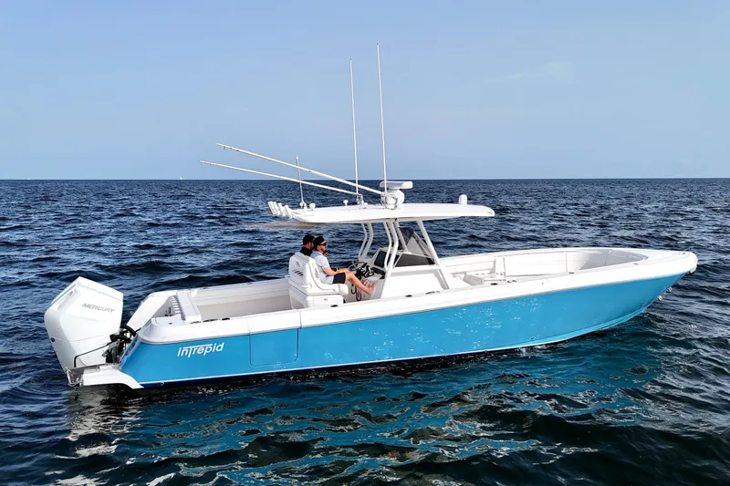 V10 400's Yacht Photos Pics 2015 Intrepid 375 Center Console boat on open water, featuring a sleek blue and white design.