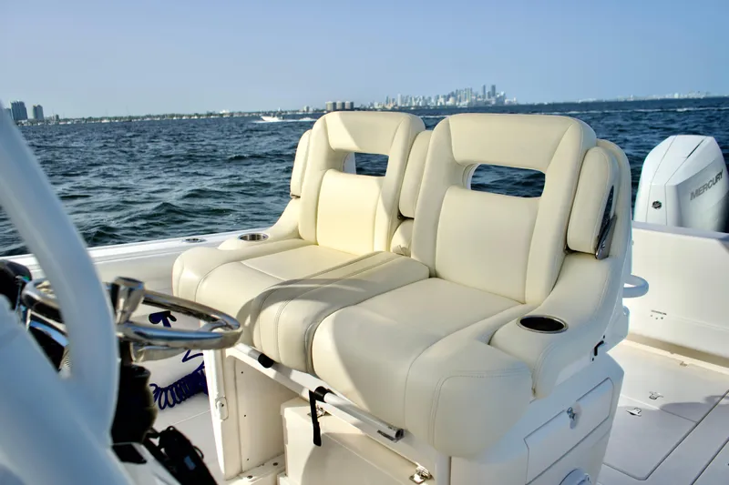V10 400's Yacht Photos Pics 2015 Intrepid 375 Center Console boat with plush seating, cruising on open water.