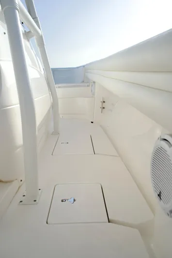 V10 400's Yacht Photos Pics 2015 Intrepid 375 Center Console boat deck with storage compartments and railing.