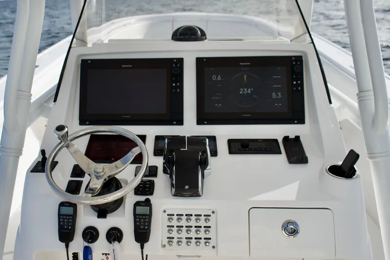 V10 400's Yacht Photos Pics Control panel of 2015 Intrepid 375 Center Console boat with dual screens and steering wheel.