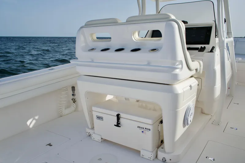 V10 400's Yacht Photos Pics 2015 Intrepid 375 Center Console boat interior with seating and storage, ocean in background.