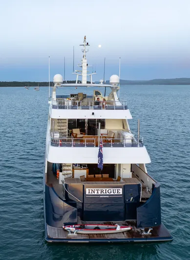 Intrigue Yacht Photos Pics Jade 95 Motor Yacht 2010 on serene water, rear view with "Intrigue" nameplate.