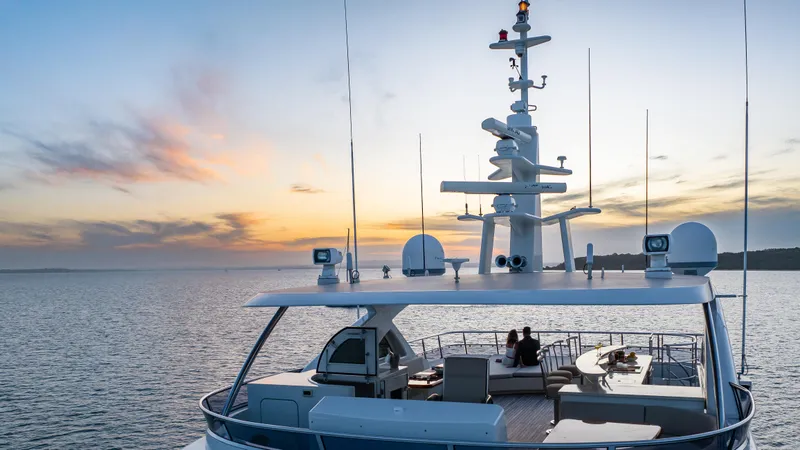 Intrigue Yacht Photos Pics Luxury Jade 95 Motor Yacht, 2010, cruising at sunset on serene waters.