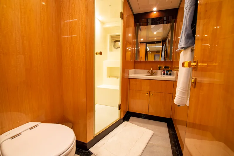 Intrigue Yacht Photos Pics Luxurious bathroom on 2010 Jade 95 Motor Yacht with wooden cabinetry and modern fixtures.