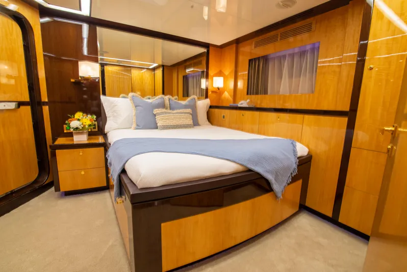 Intrigue Yacht Photos Pics Luxurious bedroom interior of 2010 Jade 95 Motor Yacht with elegant wood paneling.