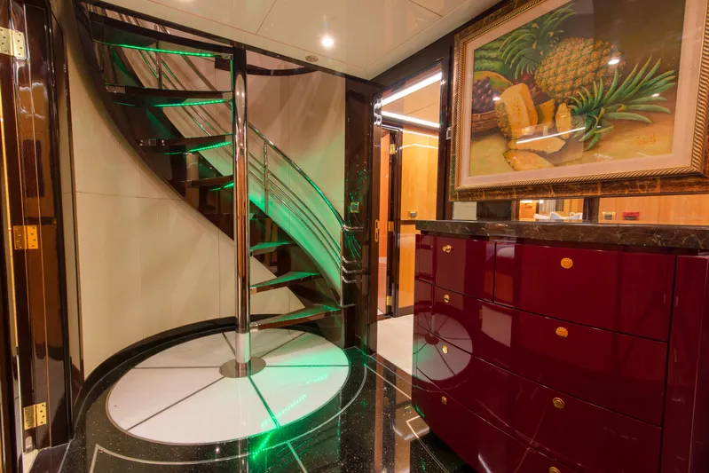 Intrigue Yacht Photos Pics Luxurious interior of 2010 Jade 95 Motor Yacht with spiral staircase and elegant decor.