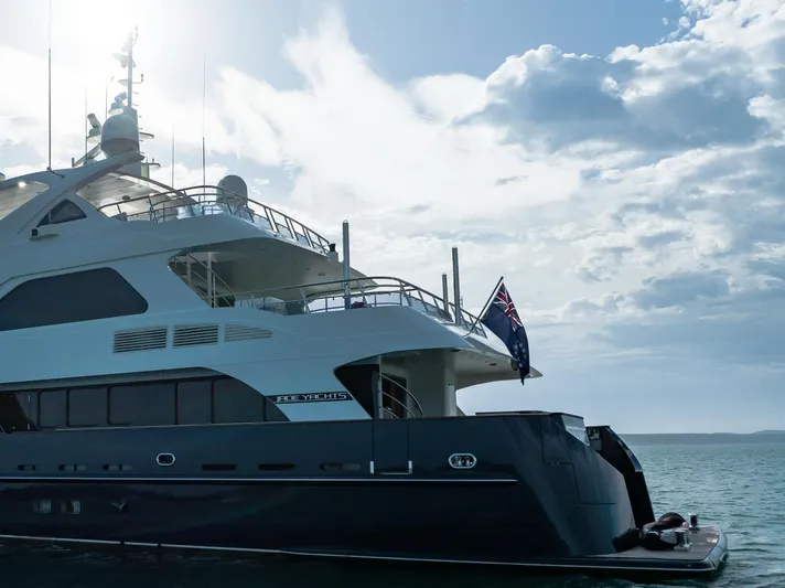 Intrigue Yacht Photos Pics Luxury Jade 95 Motor Yacht, 2010 model, docked under a cloudy sky.