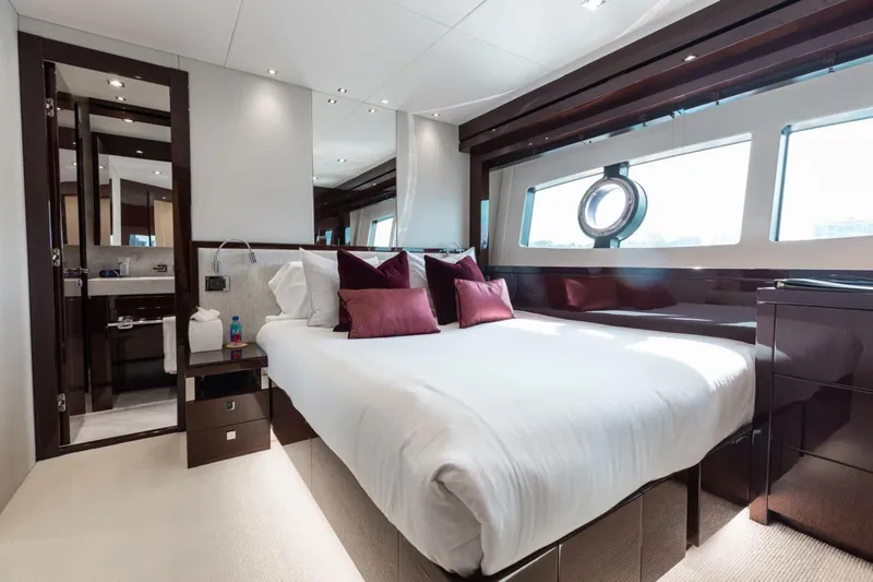 Mirracle Yacht Photos Pics Luxurious bedroom interior of 2018 Sunseeker 95 Yacht with elegant furnishings and large windows.