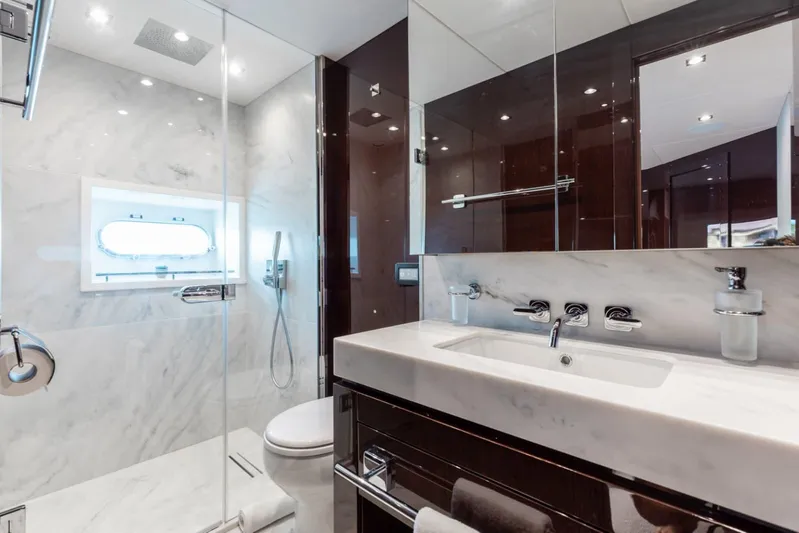 Mirracle Yacht Photos Pics Luxurious bathroom in 2018 Sunseeker 95 Yacht with marble finishes and modern fixtures.