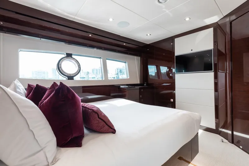Mirracle Yacht Photos Pics Luxurious bedroom interior of 2018 Sunseeker 95 Yacht with elegant decor and large windows.