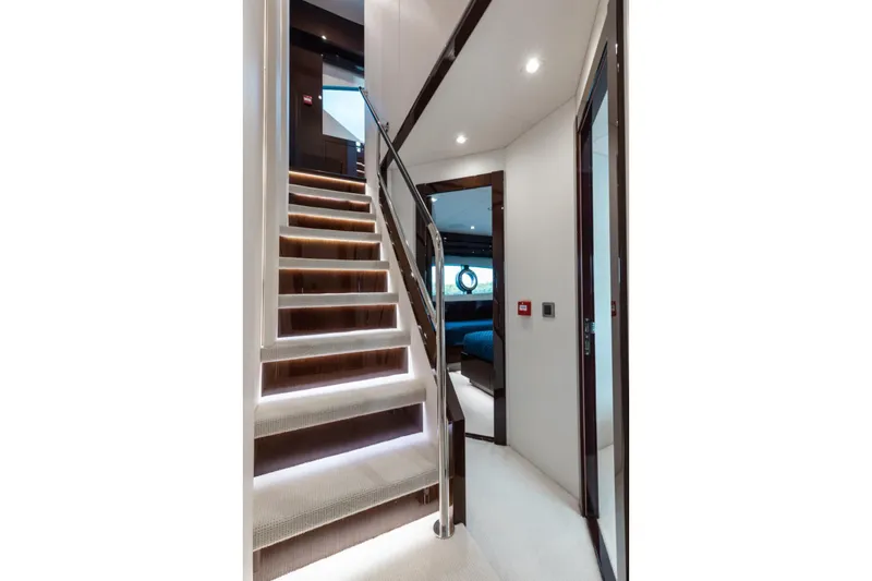 Mirracle Yacht Photos Pics Luxurious interior staircase of 2018 Sunseeker 95 Yacht, featuring elegant lighting and modern design.