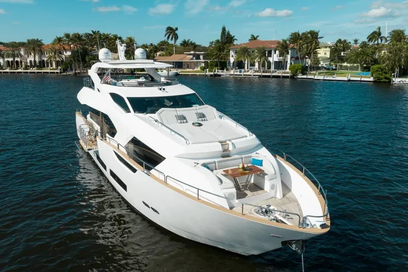 Mirracle Yacht Photos Pics Luxurious 2018 Sunseeker 95 Yacht cruising on a scenic waterway.