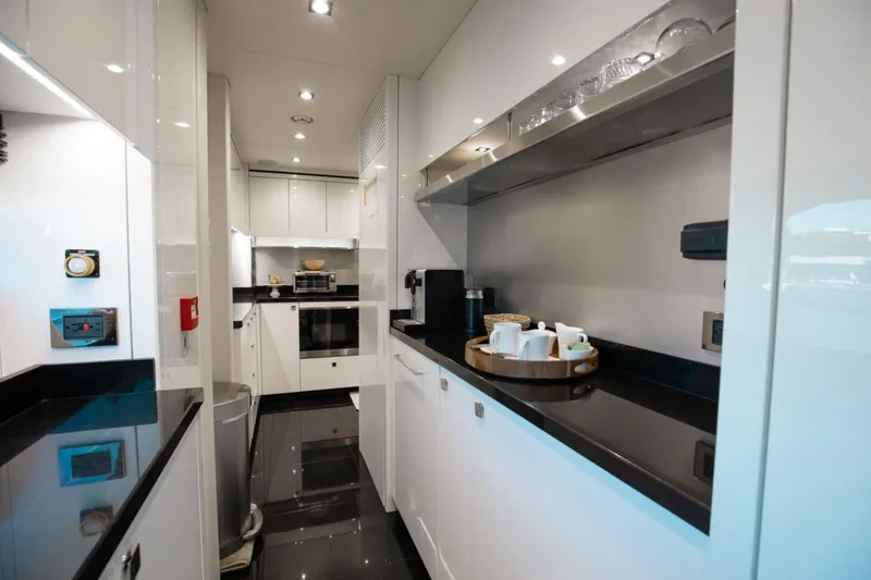 Mirracle Yacht Photos Pics Luxurious kitchen interior of 2018 Sunseeker 95 Yacht with modern appliances and sleek design.