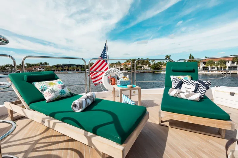 Mirracle Yacht Photos Pics Luxurious 2018 Sunseeker 95 Yacht deck with green loungers and vibrant cushions.