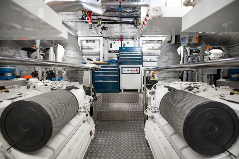 Mirracle Yacht Photos Pics Engine room of 2018 Sunseeker 95 Yacht, featuring dual engines and organized tool storage.