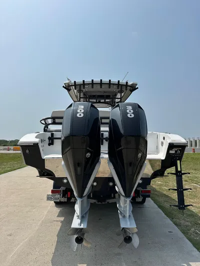  Yacht Photos Pics 2021 Fountain 34TE boat with dual outboard engines on a sunny day.