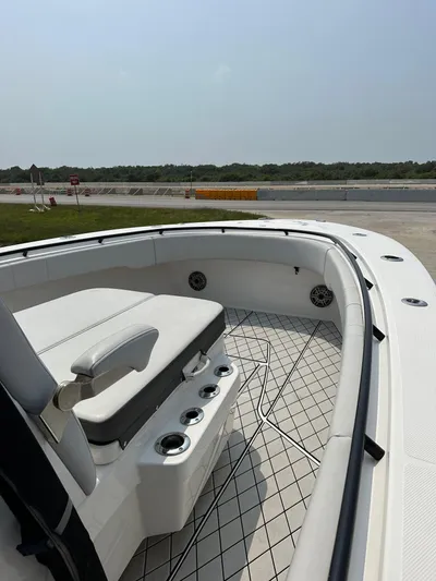  Yacht Photos Pics 2021 Fountain 34TE boat interior with seating and cup holders, docked outdoors.