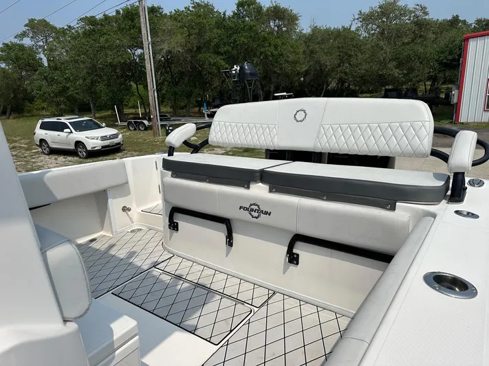  Yacht Photos Pics 2021 Fountain 34TE boat interior with white seating and storage compartments.