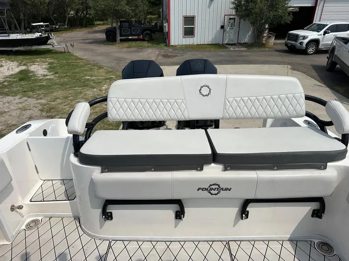  Yacht Photos Pics 2021 Fountain 34TE boat with cushioned seating and diamond-patterned upholstery.