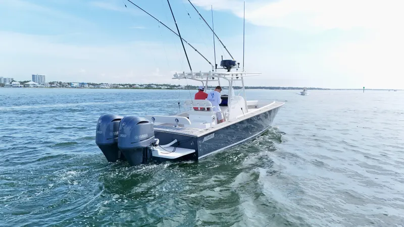 Extremely Clean / Fish Ready Yacht Photos Pics 2004 Jupiter 31 FS boat cruising on open water with dual engines.