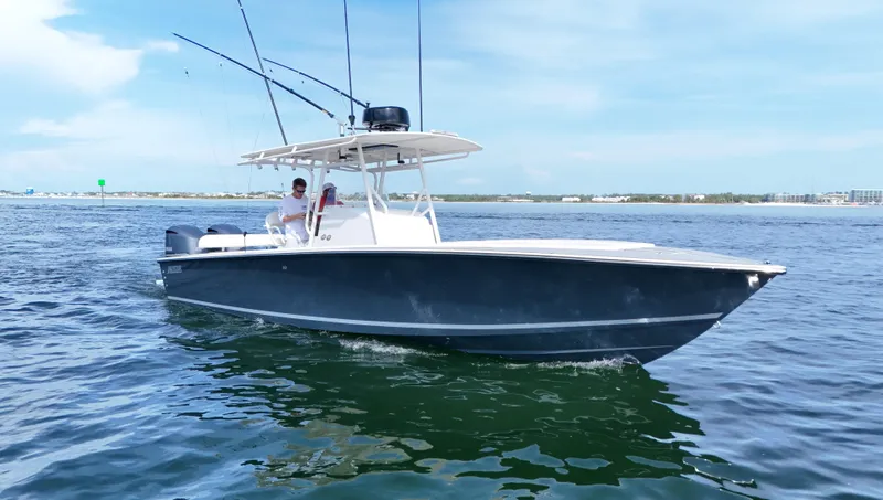 Extremely Clean / Fish Ready Yacht Photos Pics 2004 Jupiter 31 FS boat cruising on open water under a clear sky.