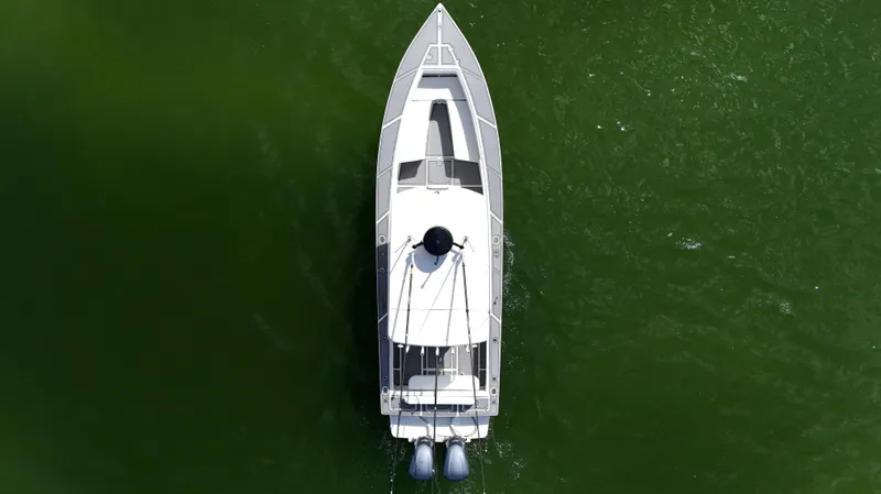 Extremely Clean / Fish Ready Yacht Photos Pics Overhead view of 2004 Jupiter 31 FS boat on green water.