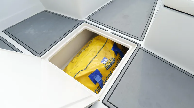 Extremely Clean / Fish Ready Yacht Photos Pics Storage compartment on a 2004 Jupiter 31 FS boat with a yellow bag inside.