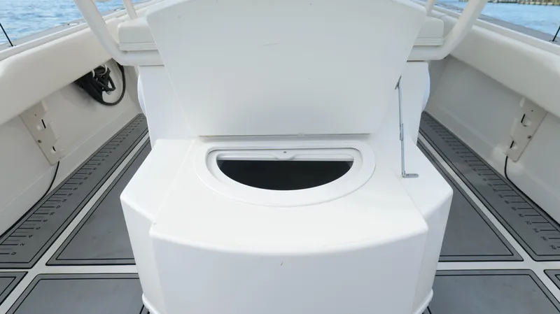 Extremely Clean / Fish Ready Yacht Photos Pics 2004 Jupiter 31 FS boat interior with open storage compartment on deck.