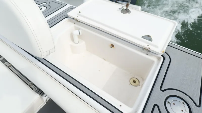 Extremely Clean / Fish Ready Yacht Photos Pics Open storage compartment on 2004 Jupiter 31 FS boat, featuring white interior and sleek design.