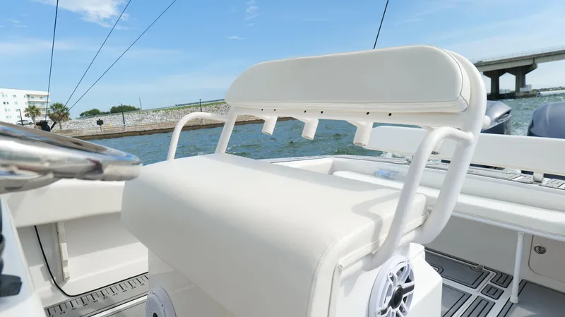 Extremely Clean / Fish Ready Yacht Photos Pics 2004 Jupiter 31 FS boat with white seating, on a sunny day near a bridge.