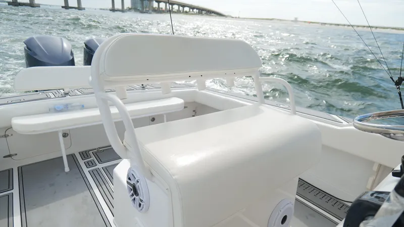 Extremely Clean / Fish Ready Yacht Photos Pics 2004 Jupiter 31 FS boat interior with seating, ocean view, and bridge in the background.
