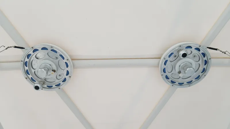 Extremely Clean / Fish Ready Yacht Photos Pics Two circular ceiling fixtures with metal chains on a white background.