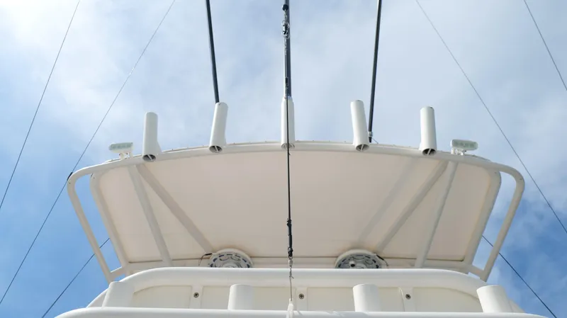 Extremely Clean / Fish Ready Yacht Photos Pics 2004 Jupiter 31 FS boat, viewed from below against a cloudy sky.