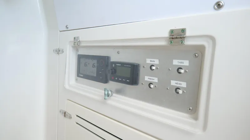 Extremely Clean / Fish Ready Yacht Photos Pics Control panel of a 2004 Jupiter 31 FS boat, featuring navigation and system switches.