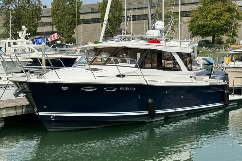  Yacht Photos Pics 2021 Cutwater C-32 Coupe docked at a marina, showcasing sleek design and modern features.
