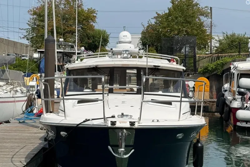  Yacht Photos Pics 2021 Cutwater C-32 Coupe docked at marina, front view.