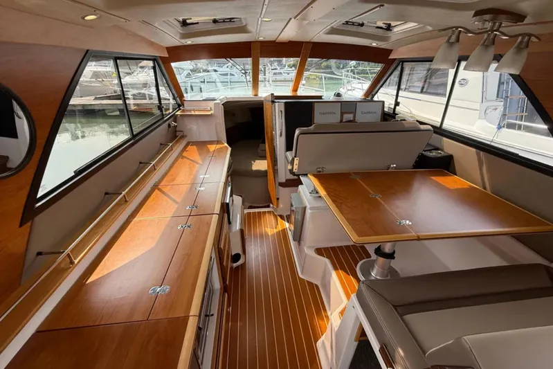  Yacht Photos Pics Interior of 2021 Cutwater C-32 Coupe boat with wood finishes and seating area.