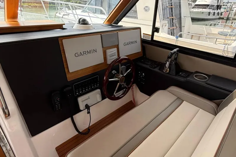  Yacht Photos Pics 2021 Cutwater C-32 Coupe helm with Garmin navigation system and luxurious seating.
