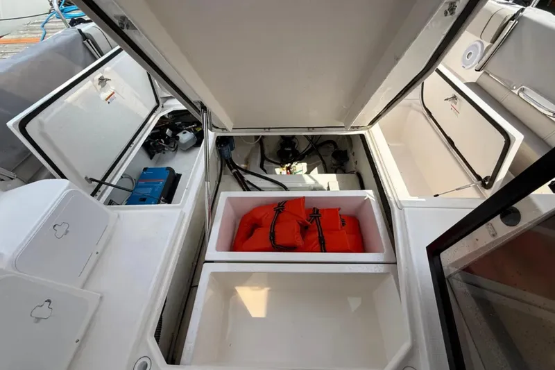 Yacht Photos Pics 2021 Cutwater C-32 Coupe storage compartments with life jackets and equipment.