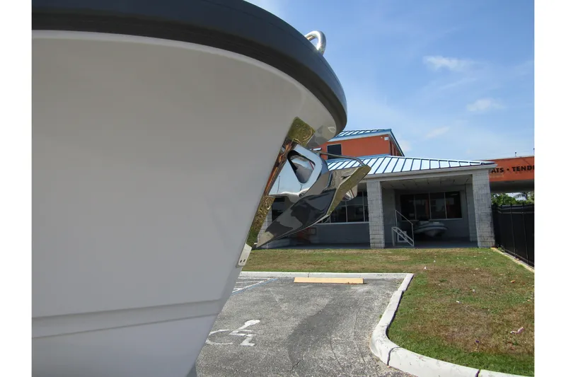  Yacht Photos Pics Front view of 2025 Nimbus Commuter 11 boat near a building.