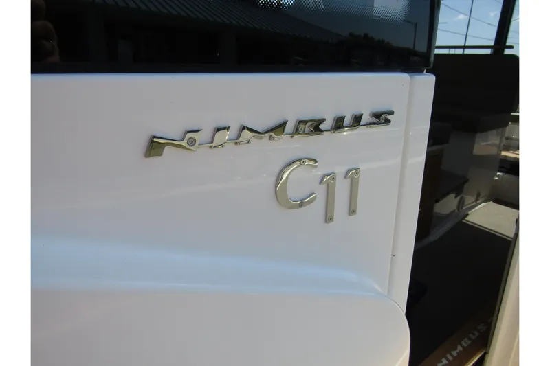  Yacht Photos Pics 2025 Nimbus Commuter 11 boat emblem on white surface.