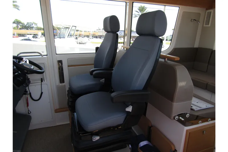  Yacht Photos Pics Interior of 2025 Nimbus Commuter 11 boat with two modern captain seats.