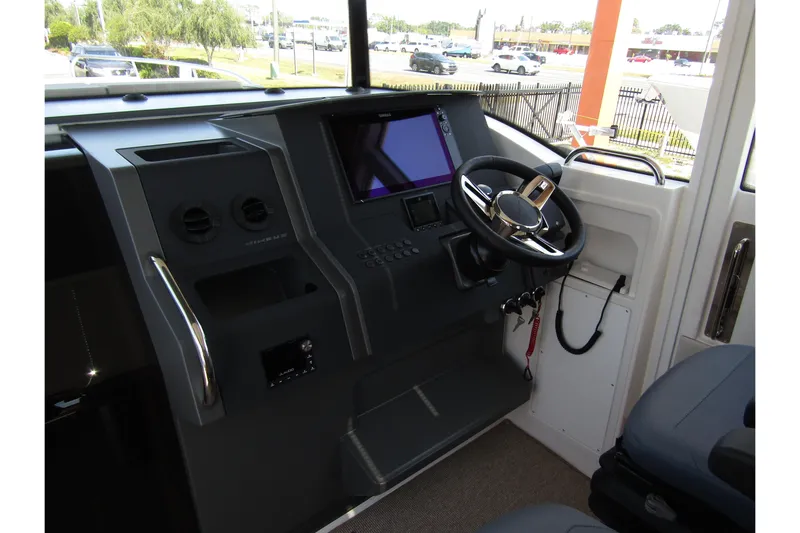  Yacht Photos Pics 2025 Nimbus Commuter 11 dashboard with steering wheel and digital display.