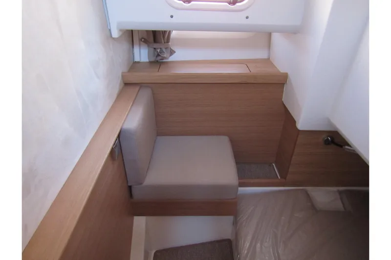  Yacht Photos Pics Interior of 2025 Nimbus Commuter 11, featuring a compact seating area with wooden accents.