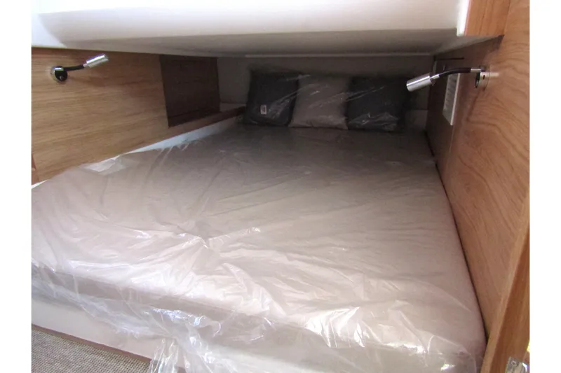 Yacht Photos Pics 2025 Nimbus Commuter 11 cabin bed with wooden interior and reading lights.