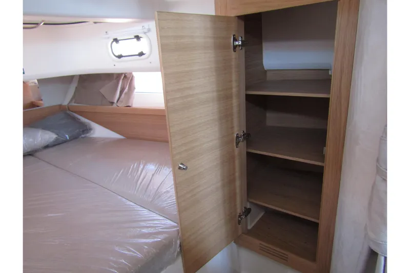  Yacht Photos Pics Interior of 2025 Nimbus Commuter 11 showing a wooden cabinet and bed.