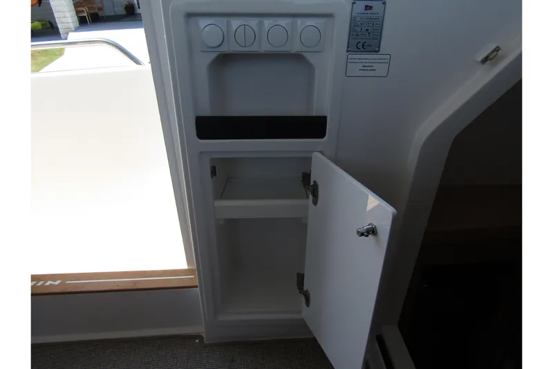  Yacht Photos Pics Open storage compartment in 2025 Nimbus Commuter 11 boat interior.